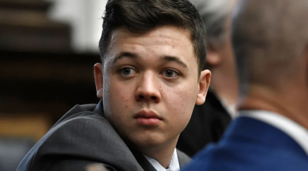Kyle Rittenhouse looks back as attorneys discuss items in the motion for mistrial presented by his defense at the Kenosha County Courthouse in Kenosha, Wis., on Wednesday, Nov. 17, 2021.